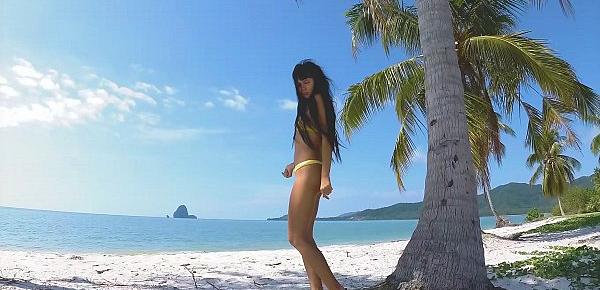 Micro bikini tease by sexy teen who walks on a beach